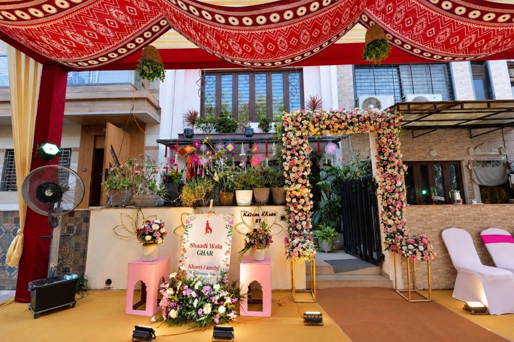 Home entrance decorated with a floral gate and welcome sign