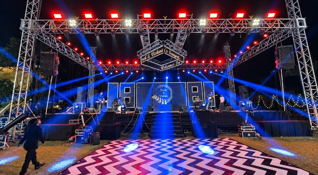 Night sangeet stage with a live band, blue lights and a dance floor